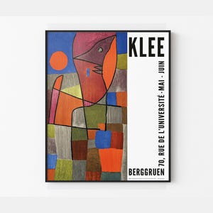 May include: A framed art print featuring a colorful abstract design with a figure and a sun. The artwork includes the name "KLEE" in bold black letters and the text "70, RUE DE L'UNIVERSITÉ - MAI - JUIN" and "BERGGRUEN".