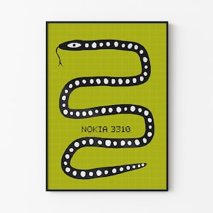 May include: A framed art print featuring a stylized black snake with white dot markings on a chartreuse green background. The text "NOKIA 3310" is printed in the center of the image. The artwork is in a minimalist style.