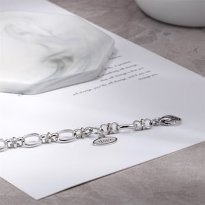 May include: A silver chain bracelet with a charm that says "Hope".