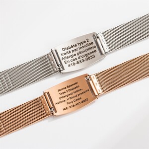 May include: Two metal bracelets with engraved medical alert information. The top bracelet is silver with the text "Diab&egrave;te type 2 trait&eacute; par insuline Allergie p&eacute;nicilline En cas d'urgence 418-8X3-0833". The bottom bracelet is gold with the text "Jennie Spencer Type 2 Diabetic (Allergies) lodine, Asthma, H Blood pressure Tony Costa ICE:518-4X1-6922".