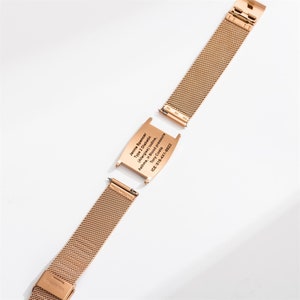 May include: A gold metal bracelet with a removable medical alert tag. The tag is engraved with the text "Jennie Spencer, Type 2 Diabetic (Allergies) Iodine, Asthma, H Blood Pressure, Tony Costa, ICE: 518-4X1-6922".