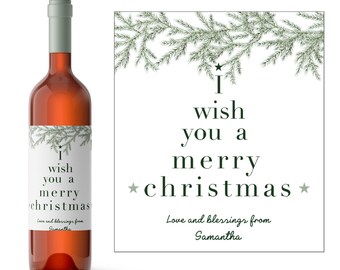 May include: A white wine bottle label with a green pine branch design and the text "I wish you a merry christmas" and "Love and blessings from Samantha".