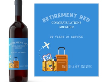 May include: A red wine bottle with a label that says "Retirement Red" and "Congratulations Gregory! 30 Years of Service". The label also has a small airplane and a suitcase with a map and passport. The text "Time for a new adventure" is on the label.