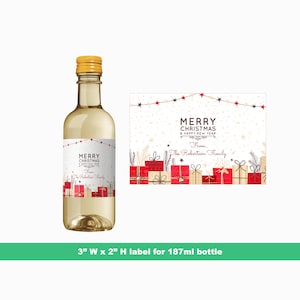 May include: A white wine bottle with a gold screw top and a label that says "Merry Christmas & Happy New Year from The Robertson Family". The label has a red and gold design with presents and stars. The bottle is 3 inches wide by 2 inches high and is for a 187 ml bottle.