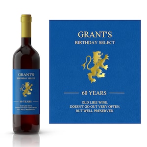 May include: A blue and gold wine bottle label with the text "GRANT'S BIRTHDAY SELECT 60 YEARS OLD LIKE WINE. DOESN'T GO OUT VERY OFTEN, BUT WELL PRESERVED."