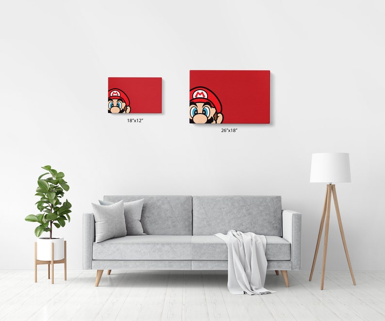 Może przedstawiać: Czerwony wydruk na pł&oacute;tnie przedstawiający zbliżenie twarzy Super Mario. Wydruk dostępny jest w dw&oacute;ch rozmiarach: 46x30 cm i 66x46 cm.
