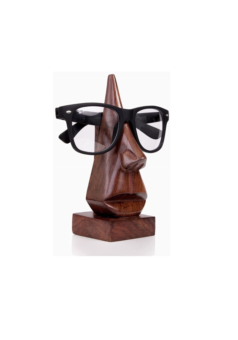 a mango wood hand carved nose shape eyeglass stand as a powerful symbol for wealth is an ideal male birthday present