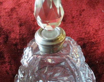 A Cut glass Perfume Bottle with Silver Neck and Glass Stopper