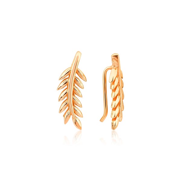 May include: A pair of gold-colored ear climbers, each shaped like a delicate leaf branch. The earrings have a curved design that follows the ear's contour, with detailed leaf textures. The background is plain white.