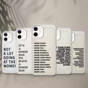 May include: Three clear phone cases with black text. The first case says "Not a lot going at the moment". The second case says "It's a good day to have a good day". The third case says "More sleep, more music, more tea, more books, more sunsets, more creating, more long walk, more laughter, more hugs, more dreaming, more road trips, more fun, more love". The fourth case says "At some point something inside me just clicked and I realised that I didn't have to deal with anyone's bullshit ever again.". The fifth case says "Surround yourself with positive energy. Your mental wellbeing, your success, and your happiness depends on it."