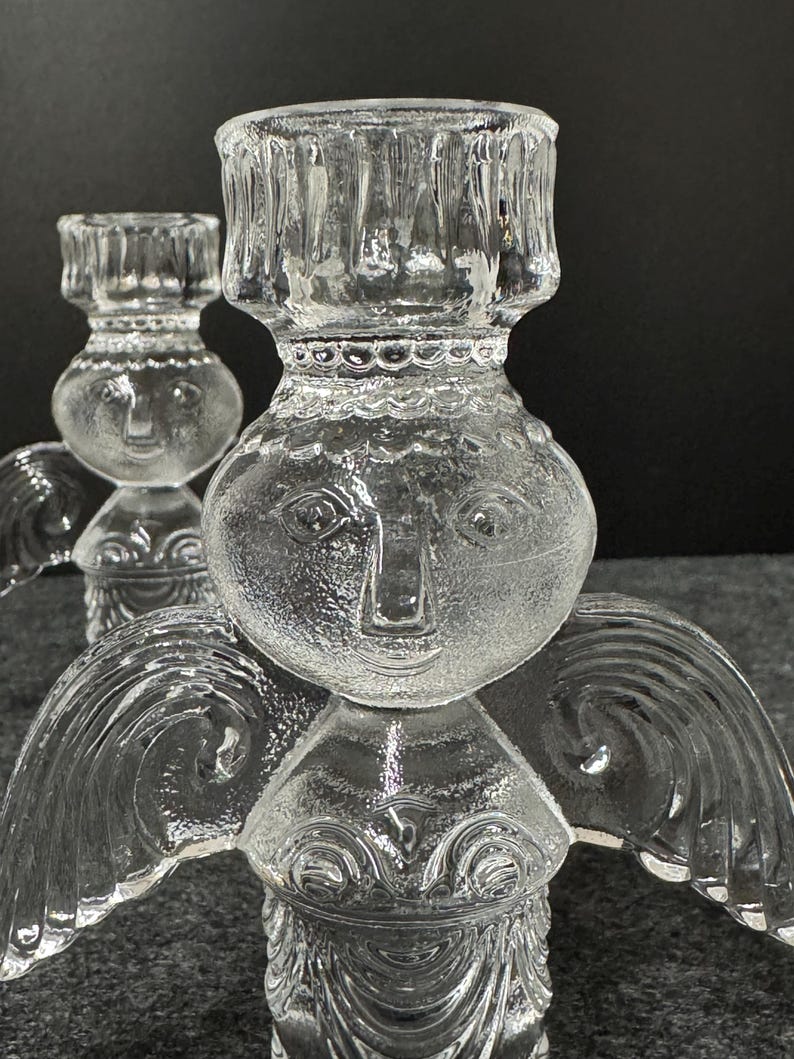 Puede incluir: Candelabros de &aacute;ngel de cristal transparente. Los candelabros tienen un dise&ntilde;o detallado con alas de &aacute;ngel y una cara. Los candelabros est&aacute;n hechos de cristal transparente y est&aacute;n dise&ntilde;ados para sostener una sola vela. Un art&iacute;culo decorativo.