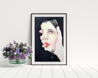 May include: A framed art print featuring a surreal illustration of a hand holding a fragmented human face against a solid black background. The face displays a single tear, brown eyes, and red lips, with the hand appearing to support the chin.