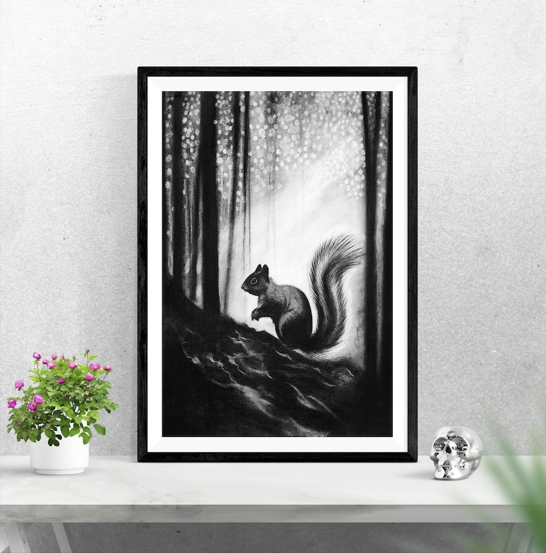 May include: A black and white charcoal drawing of a squirrel perched on a dark, textured forest floor. The squirrel is depicted in profile with a bushy tail, set against a background of tall, vertical tree trunks and dappled light.