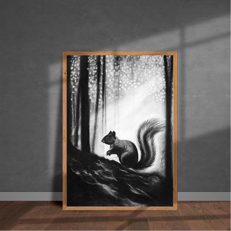 May include: A black and white charcoal drawing of a squirrel perched on a dark, textured forest floor. The background features tall, vertical tree trunks and a bright, dappled light effect filtering through the canopy, framed in a light wood border.