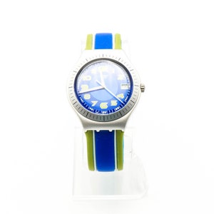 May include: A silver wristwatch with a blue face and yellow numbers. The watch has a green and blue striped strap.