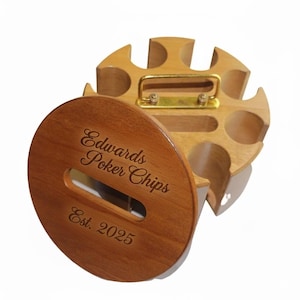 May include: Wooden poker chip holder with a lid. The lid is engraved with "Edwards Poker Chips Est. 2025". The holder has a gold-colored handle and slots for chips. The wood has a warm, natural finish.