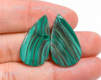 May include: Pair of green malachite gemstone cabochons in a teardrop shape. The stones have a striated pattern and are approximately 1 inch in length. MK-1319