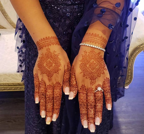 Swooshes and Delicious Dots using a mehndi/henna cone. Credit to