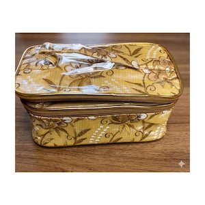 May include: A set of three ceramic nesting bowls in graduating sizes. The bowls feature a speckled, matte finish in shades of cream, beige, and brown. The largest bowl measures approximately 8 inches in diameter.