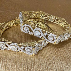 May include: A set of three ceramic mugs with a speckled, matte finish. The mugs are in shades of cream, light gray, and dark gray. Each mug has a simple, minimalist design and a rounded handle.