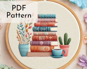 May include: A PDF pattern for an embroidery hoop art project featuring a stack of colorful books, a potted cactus, a potted plant with green stems and orange flowers, and a cup of coffee. The text "PDF Pattern" is displayed in a white box at the top of the image.