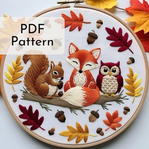 May include: Embroidered hoop art featuring a fox, squirrel, and owl sitting on a branch with autumn leaves and acorns. The text "PDF Pattern" is in the top left corner.