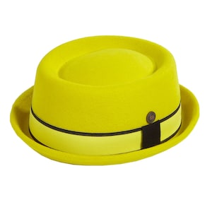 May include: A bright yellow wool fedora with a black and yellow band. The hat has a flat top and a slightly curved brim.