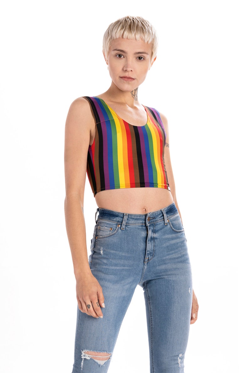 May include: A cropped tank top with vertical rainbow stripes. The tank top is sleeveless and has a scoop neck.