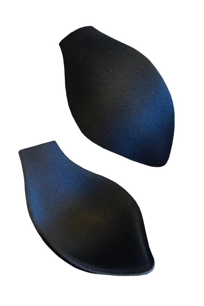 May include: Two black foam bra inserts, shaped like a teardrop, designed to add volume to a bra cup.