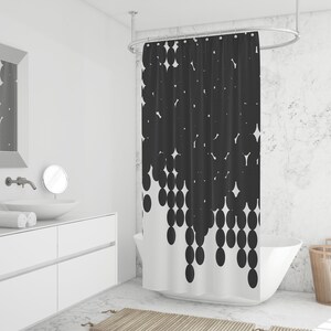 Puede incluir: Una cortina de ducha en blanco y negro con un patr&oacute;n geom&eacute;trico de c&iacute;rculos. Los c&iacute;rculos est&aacute;n dispuestos en cascada, con los c&iacute;rculos m&aacute;s grandes en la parte superior y los c&iacute;rculos m&aacute;s peque&ntilde;os en la parte inferior. La cortina de ducha est&aacute; colgada en un ba&ntilde;o blanco con una ba&ntilde;era blanca y un tocador blanco.