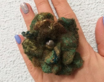 The ring is large, green with a transition to brown Color, of wool