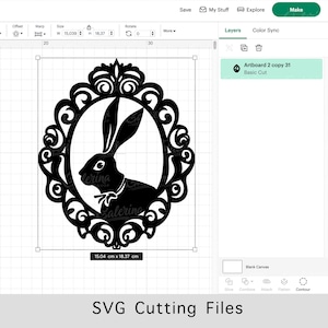 May include: A black silhouette of a rabbit inside a decorative ornate frame. The frame is detailed with intricate swirls and curves. The image is 15.04 cm by 18.37 cm.