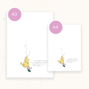 May include: Two white art prints, A3 and A4 sizes, featuring a minimalist illustration of Winnie the Pooh and Piglet. The yellow Pooh is suspended by a string, holding a green and pink object. Text reads, "We didn't realize we were making memories, we just knew we were having fun."