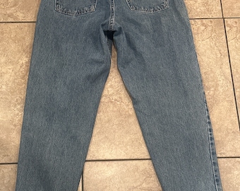 May include: A pair of light blue denim jeans with a brown leather patch on the back waistband that says "Levi's" and "Original  Fit".