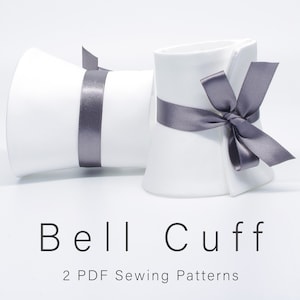Puede incluir: Dos puños de campana de tela blanca con lazos de cinta de satén gris. El texto "Bell Cuff" y "2 PDF Sewing Patterns" está impreso debajo de los puños.