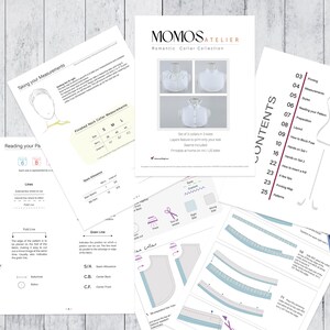 May include: A set of three white collars with different styles, including a ruffled collar, a Peter Pan collar, and a classic collar. The collars are part of a sewing pattern set called "Romantic Collar Collection" by MOMOS ATELIER. The pattern set includes instructions for printing, cutting, and sewing the collars.