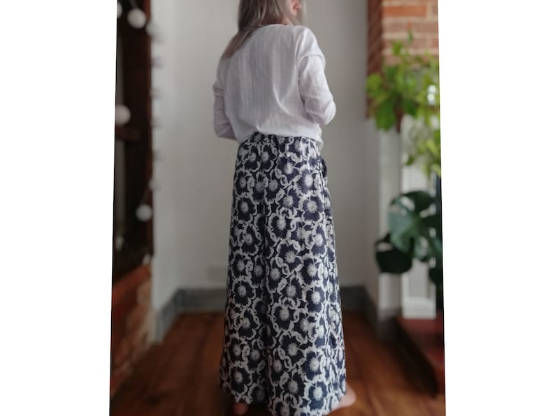 May include: A long, flowing skirt with a black and white floral print. The skirt is made of a soft, lightweight fabric and has a wrap-around style.