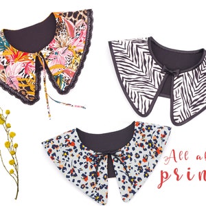 May include: Three different fabric collars with a black backing. The collars are in a zebra print, a leopard print, and a floral print. The text "All about prints" is in red at the bottom of the image.