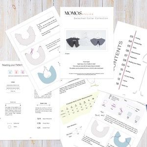 May include: A set of sewing patterns for detached collars in various sizes, from toddler to adult. The patterns are printed on white paper and include instructions for sewing the collars. The patterns are laid out on a wooden table with a measuring tape, scissors, and a pencil.