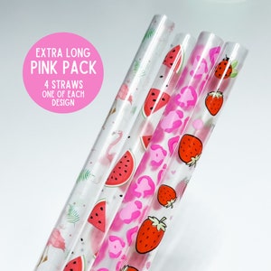 May include: Set of four extra long pink reusable drinking straws with different designs. The straws feature pink flamingos, watermelons, strawberries, and pink leopard print.