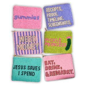 May include: A collection of six beaded pouches in various colors, each with a unique text design. The pouches include phrases like "gummies," "receipts," "weed money," "pickle princess," "Jesus saves I spend," and "eat, drink, & remarry."