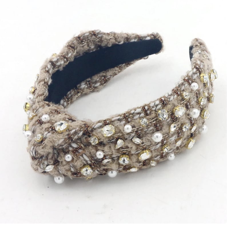 May include: A brown tweed headband with pearl and rhinestone embellishments.
