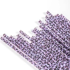 May include: A bundle of purple and black patterned drinking straws with a leopard print design.