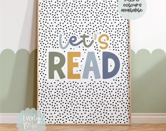 Pode incluir: Um cartaz branco imprimível com bolinhas pretas e o texto "Let's Read" em letras coloridas. As letras são em tons de verde, azul, amarelo e laranja.