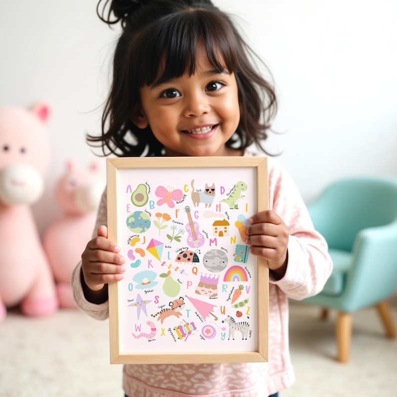 May include: A framed alphabet chart with colorful illustrations of animals, objects, and letters. The chart is on a white background with a light wood frame.