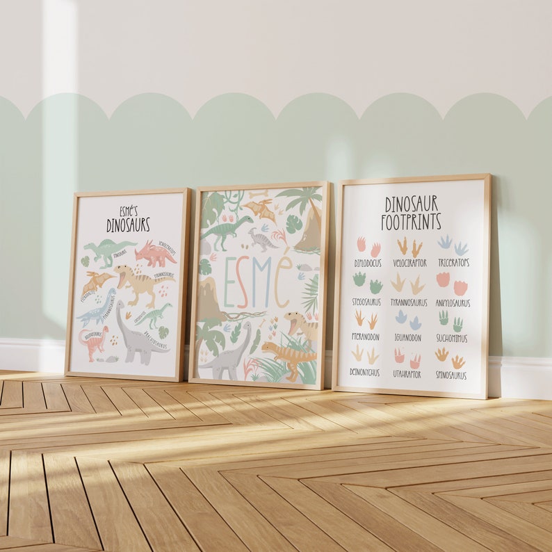 May include: Three framed prints with a dinosaur theme. The left print features a variety of dinosaurs with the text "Esme's Dinosaurs". The middle print features a jungle scene with the name "Esme" in large letters. The right print features a dinosaur footprint chart with the text "Dinosaur Footprints".