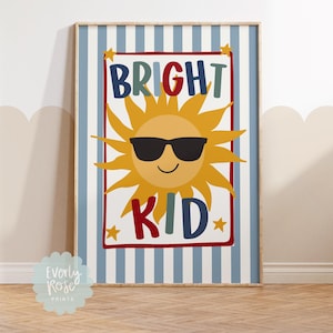 May include: A framed print with a blue and white striped background. The print features a smiling sun wearing sunglasses, with the words "BRIGHT KID" in colorful letters. Small yellow stars are in each corner of the text.