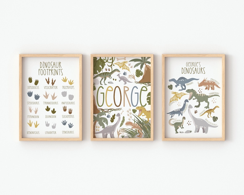 May include: Three framed prints with a dinosaur theme. The left print shows dinosaur footprints with the names of the dinosaurs below each footprint. The middle print has the name "GEORGE" in large letters with a jungle scene in the background. The right print shows various dinosaurs with their names below each dinosaur.