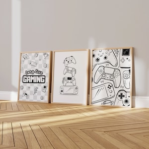 May include: Three framed black and white illustrations of video game controllers. The left frame has the text "long live GAMING" and various video game icons. The middle frame has a stack of four video game controllers. The right frame has a pattern of video game controllers.