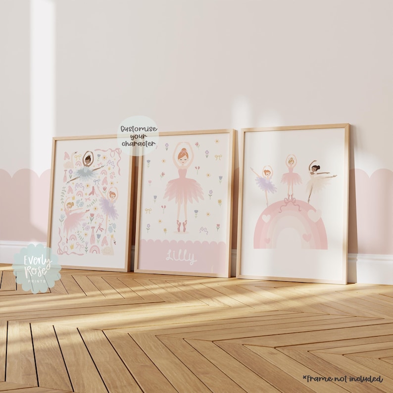 May include: Three framed prints with a pink and white color scheme featuring illustrations of ballerinas. The center print has the name "Lilly" at the bottom. The print on the right shows three ballerinas standing on a rainbow. The print on the left has a variety of pink and white illustrations.